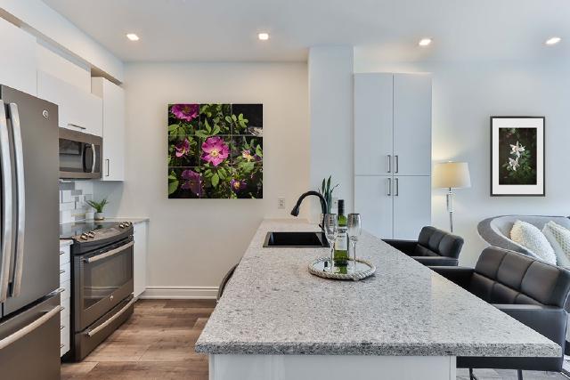 photographs of flowers by Subalpine Design hung on the wall in a kitchen living area